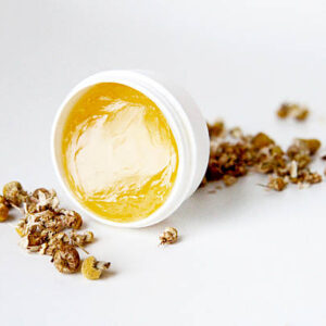 Chamomile beauty product and dried chamomile plant