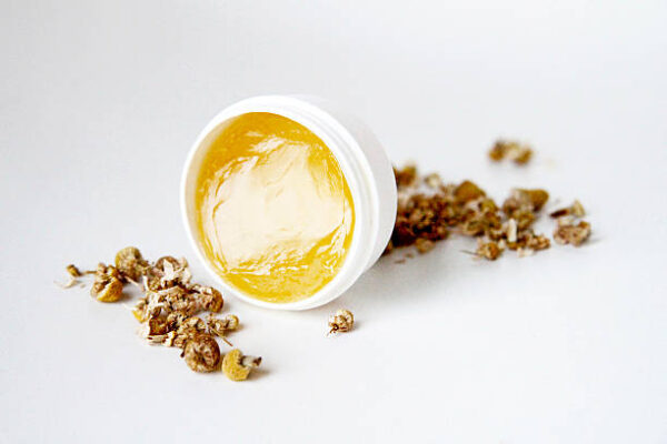 Chamomile beauty product and dried chamomile plant